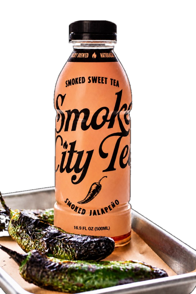 Smoke City Tea Smoked Jalapeño bottle with roasted jalapeños on a sheet pan
